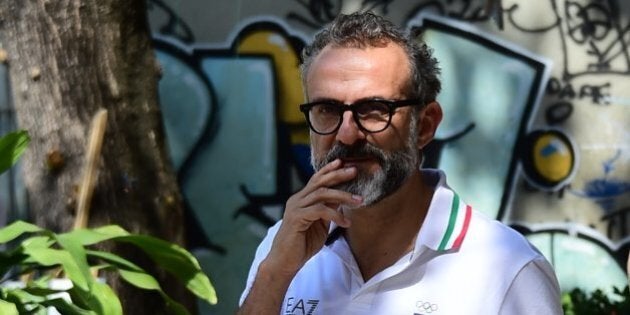 Italian chef Massimo Bottura walks in Rio de Janeiro, as the Rio 2016 Olympic Games are being held in Brazil, on August 9, 2016.Restaurant-goers usually pay hundreds of euros to eat the creations of Massimo Bottura, but during the Olympics he is serving up scraps to poor Brazilians for free. Bottura's ingredients are garbage-bound surplus food donated by the catering companies at the Olympic park and athletes' village. / AFP / TASSO MARCELO (Photo credit should read TASSO MARCELO/AFP/Getty Images)