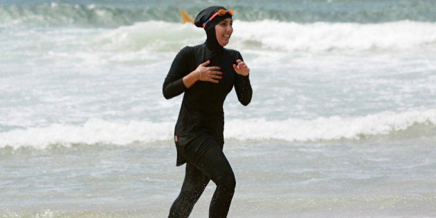 Twenty-year-old trainee volunteer surf life saver Mecca Laalaa runs along North Cronulla Beach in Sydney during her Bronze medallion competency test January 13, 2007. Specifically designed for Muslim women, Laalaa's body-covering swimming costume has been named the