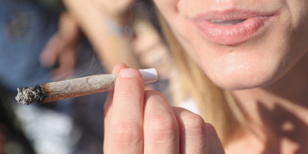 BERLIN, GERMANY - AUGUST 13: An activists smokes a marijuana joint prior to marching in the annual Hemp Parade (Hanfparade) on August 13, 2016 in Berlin, Germany. German proponents of cannabis legalization are hoping that the legalization in several states in the USA in recent years will increase the likelihood of legalization in Germany. (Photo by Sean Gallup/Getty Images)