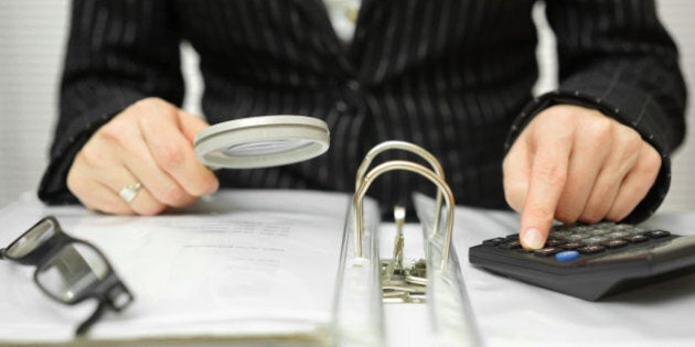 accountant is examining invoices and documents