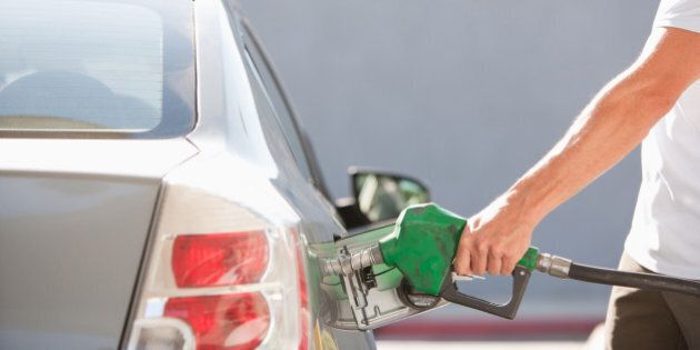 Man filling car with gas