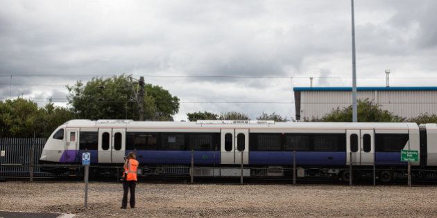 A photographer watches an Aventra Class 345 electric multiple-unit test train, manufactured by Bombarider Inc., to be used on the Elizabeth Line as part of the Crossrail project, travel on the test track at the Bombardier Transportation UK Ltd. Rail Vehicles Production Site in Derby, U.K., on Friday, July 29, 2016. Crossrail, approved in 2008 to cut journey times across London and the Southeast, is Europe's largest construction project. Photographer: Simon Dawson/Bloomberg via Getty Images