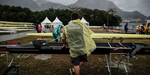 A New Zealand's technical staff member prepares a boat for a training session at the Lagoa stadium following the cancellation of the day's races due to bad weather condition during the Rio 2016 Olympic Games in Rio de Janeiro on August 10, 2016. / AFP / JEFF PACHOUD (Photo credit should read JEFF PACHOUD/AFP/Getty Images)