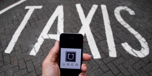 A photo illustration shows the Uber app logo displayed on a mobile telephone, as it is held up for a posed photograph in central London, Britain October 28, 2016. REUTERS/Toby Melville/Illustration