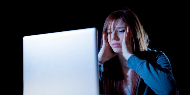 teenager girl suffering cyberbullying scared and depressed exposed to cyber bullying and internet harassment feeling sad and vulnerable in internet stalker danger and abuse problem