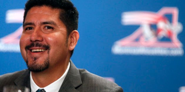 Montreal Alouettes quarterback Anthony Calvillo laughs with the media after he announced his retirement from CFL football in Montreal, January 21, 2014. REUTERS/Christinne Muschi (CANADA - Tags: SPORT FOOTBALL)