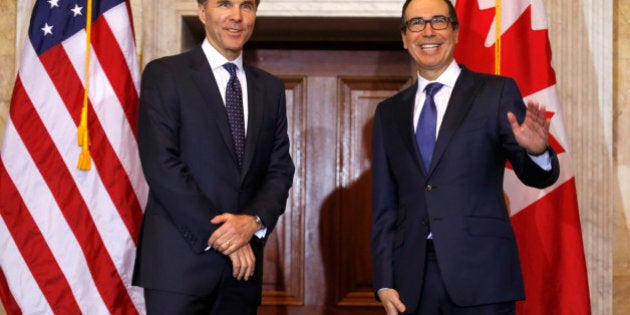 U.S. Secretary of the Treasury Steven Mnuchin (R) waves during a meeting with Canadian Finance Minister William F. Morneau at the Treasury Building in Washington, U.S., March 1, 2017. REUTERS/Joshua Roberts