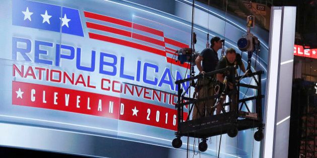 The main stage on the convention floor at the Quicken Loans Arena in downtown Cleveland, Ohio, is prepared for the upcoming Republican National Convention, as workers stand in a man lift on Wednesday, July 13, 2016. (AP Photo/Gene J. Puskar)