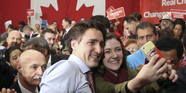 Liberal leader and Canada's Prime Minister-designate Justin Trudeau poses for a selfie while greeting supporters during a rally in Ottawa, Ontario, October 20, 2015. Trudeau, having trounced his Conservative rivals, will face immediate pressure to deliver on a swathe of election promises, from tackling climate change to legalizing marijuana. REUTERS/Chris Wattie