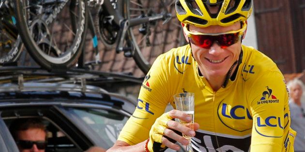 Britain's Chris Froome, wearing the overall leader's yellow jersey, celebrates with a glass of champagne during the twenty-first stage of the Tour de France cycling race over 113 kilometers (70.2 miles) with start in Chantilly and finish in Paris, France, Sunday, July 24, 2016. (AP Photo/Christophe Ena)