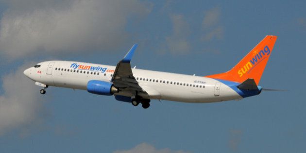 'Fort Lauderdale, USA - January 11, 2009: Sunwing Boeing 737 passenger jet departs Fort Lauderdale back to Canada. Sunwing is a popular low cost airline.'