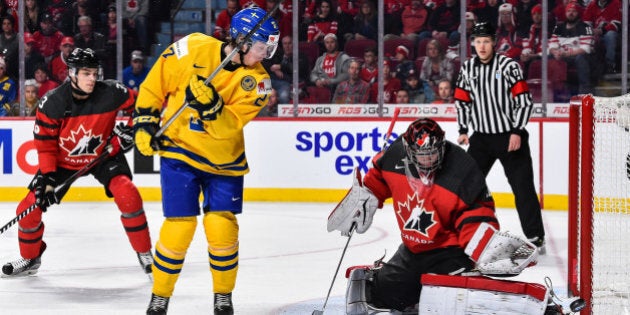 MONTREAL, QC - JANUARY 04: Goaltender Carter Hart #31 of Team Canada makes a pad save on Jonathan Dahlen #27 of Team Sweden during the 2017 IIHF World Junior Championship semifinal game at the Bell Centre on January 4, 2017 in Montreal, Quebec, Canada. (Photo by Minas Panagiotakis/Getty Images)