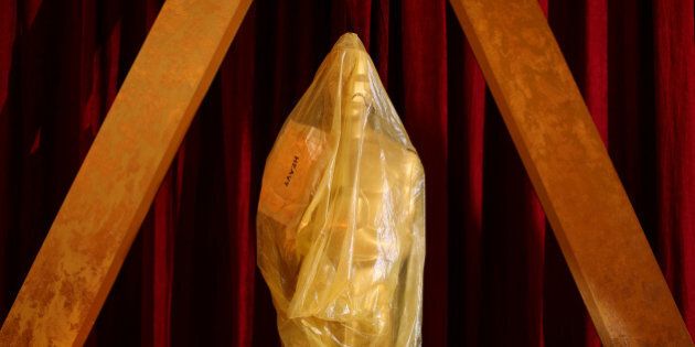 An Oscar statue sits wrapped in plastic along the red carpet as preparations continue for the 89th Academy Awards in Hollywood, California, U.S. February 25, 2017. REUTERS/Mike Blake