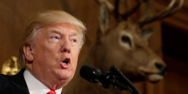 Under a mounted deer, U.S. President Donald Trump speaks before signing the Antiquities Executive Order at the Department of the Interior in Washington, DC, U.S. April 26, 2017. REUTERS/Kevin Lamarque