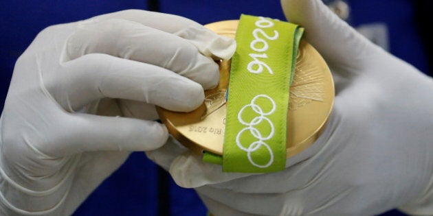 A worker from the Casa da Moeda do Brasil (Brazilian Mint) prepares a Rio 2016 Olympic medal in Rio de Janeiro, Brazil, June 28, 2016. REUTERS/Sergio Moraes