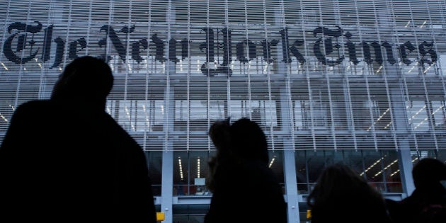 People line up for taxi across the street from the New York Times head office in New York, February 7, 2013. The New York Times Co, on Thursday, reported higher quarterly revenue as more people paid for its digital newspapers, and its shares jumped 11 percent. REUTERS/Carlo Allegri (UNITED STATES - Tags: BUSINESS MEDIA)