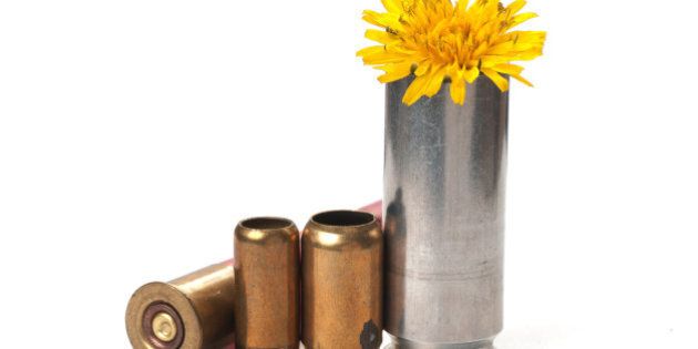 Used bullet casings on white with shadow and flower