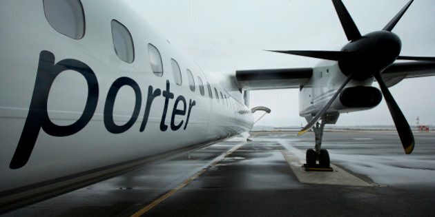 A Porter Airlines Inc. Q400 plane stands on the tarmac at Billy Bishop Toronto City Airport in Toronto, Ontario, Canada, on Wednesday, April 10, 2013. Porter Airlines Inc., the Canadian carrier that now flies only turboprops, plans to add its first jets, at least 12 Bombardier Inc. CSeries airliners, to start long-haul flights in an expanded challenge to Air Canada and WestJet Airlines Ltd. Photographer: Norm Betts/Bloomberg via Getty Images
