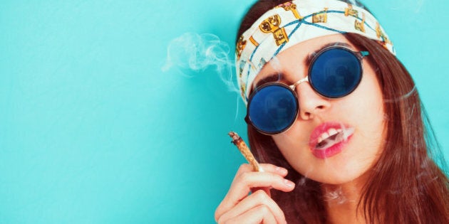 Hippie girl portrait smoking and wearing sunglasses