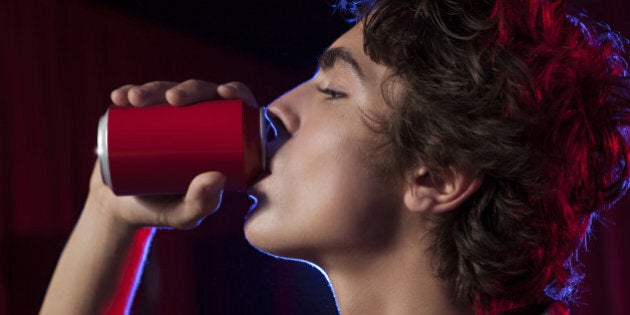 Teen drinking from a can