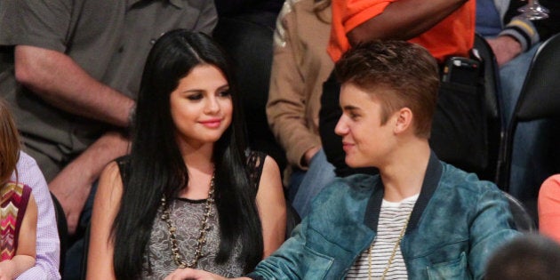 LOS ANGELES, CA - APRIL 17: Selena Gomez (L) and Justin Bieber attend a basketball game between the San...