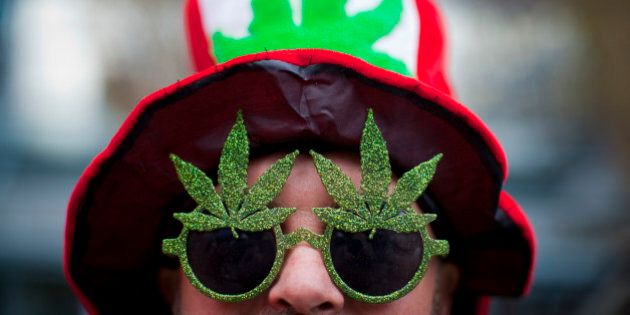 A man, wearing a marijuana-themed hat and sunglasses, is pictured at the Vancouver Art Gallery during the annual 4/20 day, which promotes the use of marijuana, in Vancouver, British Columbia April 20, 2013. REUTERS/Ben Nelms (CANADA - Tags: HEALTH SOCIETY POLITICS CIVIL UNREST DRUGS)