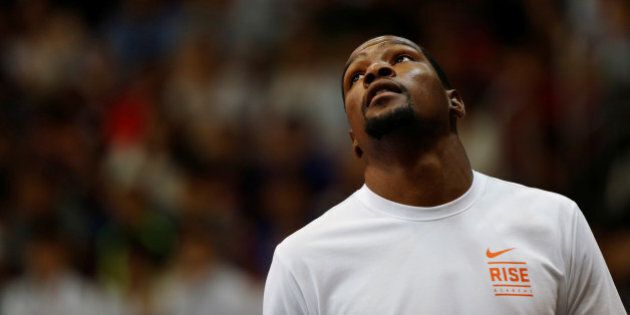 NBA player Kevin Durant looks up during a promotional event in Hong Kong, China July 12, 2016. REUTERS/Bobby Yip
