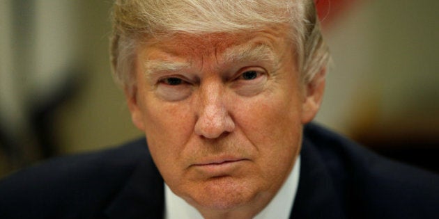 U.S. President Donald Trump looks up while hosting a House and Senate leadership lunch at the White House in Washington, U.S. March 1, 2017. REUTERS/Kevin Lamarque