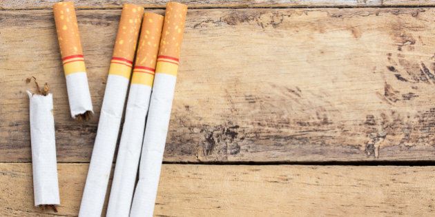 Tobacco cigarettes on a wooden table background. cigarette with health concept