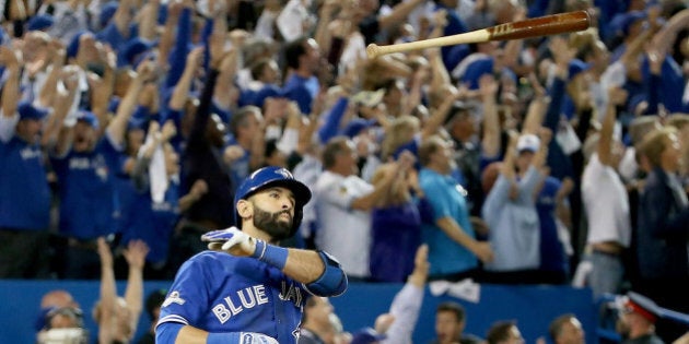 TORONTO, ON - OCTOBER 14: Jose Bautista #19 of the Toronto Blue Jays throws his bat up in the air after he hits a three-run home run in the seventh inning against the Texas Rangers in game five of the American League Division Series at Rogers Centre on October 14, 2015 in Toronto, Canada. (Photo by Tom Szczerbowski/Getty Images)