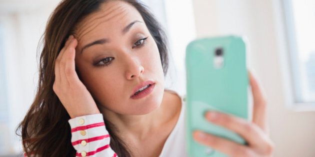 Stressed woman using cell phone