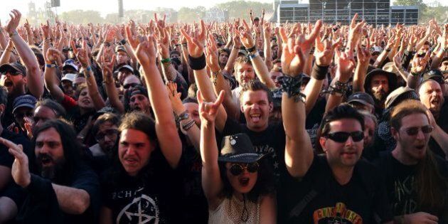 Festival goers gestures as they attend the Hellfest heavy metal and hard rock music festival in Clisson on June 16, 2017. / AFP PHOTO / LUDOVIC MARIN (Photo credit should read LUDOVIC MARIN/AFP/Getty Images)