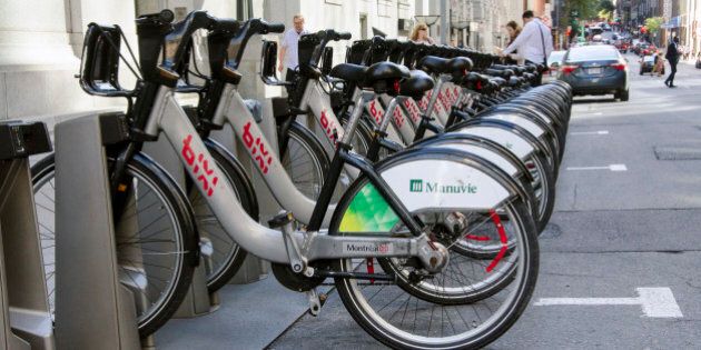 Montreal, Quebec, Canada - 18 July 2016 - Shared bikes are lined up in the streets. First large-scale in North America city public bicycle sharing system Bixi. Bicycles in bike dock as editorial