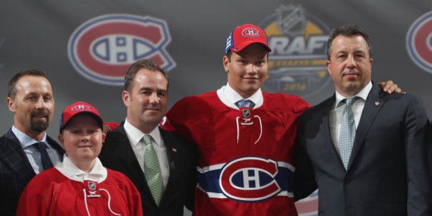BUFFALO, NY - JUNE 24: Mikhail Sergachev poses with team personnel after being selected ninth overall by the Montreal Canadiens during round one of the 2016 NHL Draft at First Niagara Center on June 24, 2016 in Buffalo, New York. (Photo by Dave Sandford/NHLI via Getty Images)