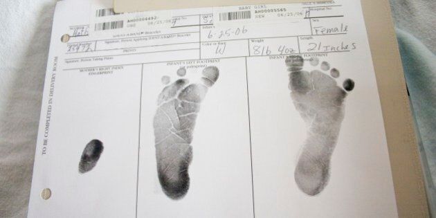 Newborn baby footprints on official document