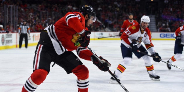 Oct 22, 2015; Chicago, IL, USA; Chicago Blackhawks center Andrew Shaw (65) shoots the puck against the Florida Panthers during the third period at the United Center. Chicago Blackhawks defeat the Florida Panthers 3-2. Mandatory Credit: Mike DiNovo-USA TODAY Sports