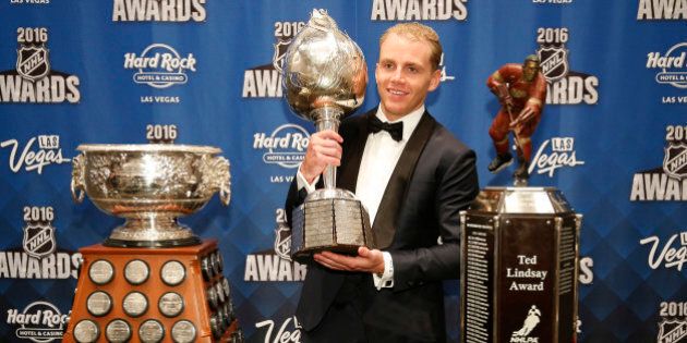 Chicago Blackhawks' Patrick Kane poses with the Art Ross Trophy, left, the Hart Trophy, center, and the Ted Lindsay Award after winning the awards at the NHL Awards show, Wednesday, June 22, 2016, in Las Vegas. (AP Photo/John Locher)