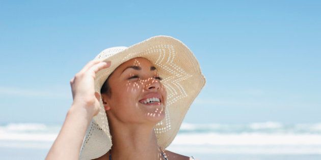 Woman wearing sun hat on beach