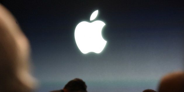 The Apple Inc. logo is seen before the start of an Apple Inc. event in Cupertino, California, U.S., on Monday, March 21, 2016. Apple Inc. Chief Executive Officer Tim Cook is expected to unveil a smaller iPhone Monday in attempt to woo those who are holding on to older versions. Photographer: David Paul Morris/Bloomberg via Getty Images