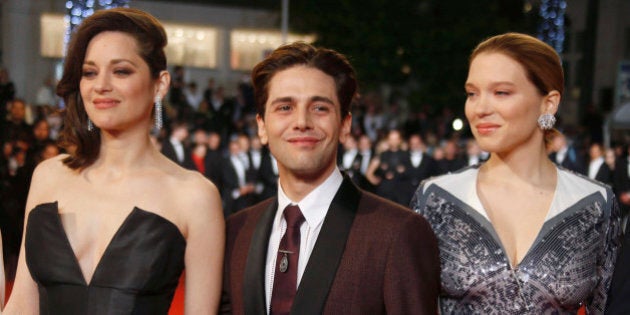 Director Xavier Dolan (C), cast members Lea Seydoux (R) and Marion Cotillard pose on the red carpet as they arrive for the screening of the film