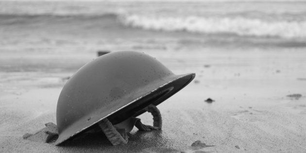British Army Helmet left on the beach at Dunkirk after the retreat from the Germans 1940.re-enactment.