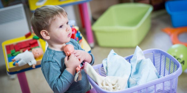 Little boy plays with a doll