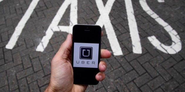 A photo illustration shows the Uber app logo displayed on a mobile telephone, as it is held up for a posed photograph in central London, Britain October 28, 2016. REUTERS/Toby Melville/Illustration