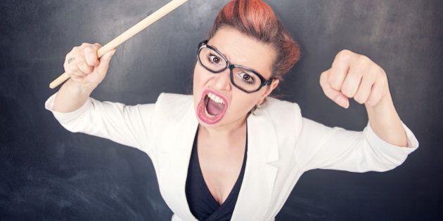 Angry screaming teacher with pointer on the chalkboard blackboard background