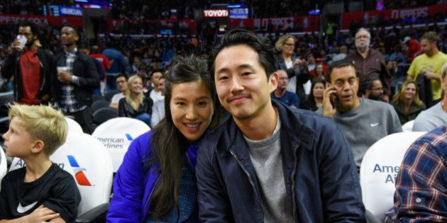 LOS ANGELES, CA - NOVEMBER 07: Steven Yeun (R) and Joana Pak attend a basketball game between the Detroit Pistons and the Los Angeles Clippers at Staples Center on November 7, 2016 in Los Angeles, California. (Photo by Noel Vasquez/GC Images)