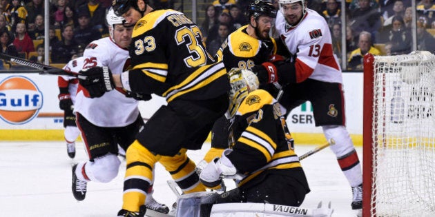 Apr 9, 2016; Boston, MA, USA; Ottawa Senators right wing Chris Neil (25) battles for a loose puck with Boston Bruins defenseman Zdeno Chara (33) in front of goalie Jonas Gustavsson (50) during the second period at TD Garden. Mandatory Credit: Bob DeChiara-USA TODAY Sports