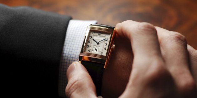 Businessman checking his wristwatch - nice shot over the shoulder. It's time to go to the next appointment.