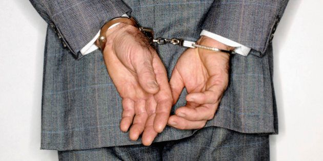 Businessman in handcuffs,rear view