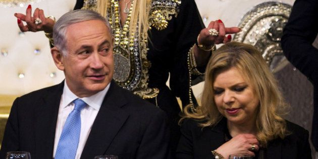 Israeli Prime Minister Benjamin Netanyahu (L) and his wife Sara (R) attend the Mimona ceremony at the Israeli town of Or Akiva near Caesarea April 11, 2015. REUTERS/Amir Cohen