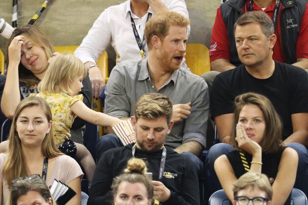 Prince Harry (R) sits with David Henson's wife Hayley Henson (L) and daugther Emily Henson at the Sitting Volleyball Finals on day 5 of the Invictus Games in Toronto on Sept. 27, 2017 in Toronto, Canada.